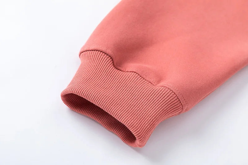 Close-up of a pink sweatshirt sleeve on a white background